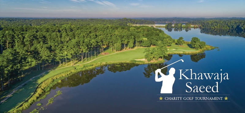 an overhead view of a golf course and lake