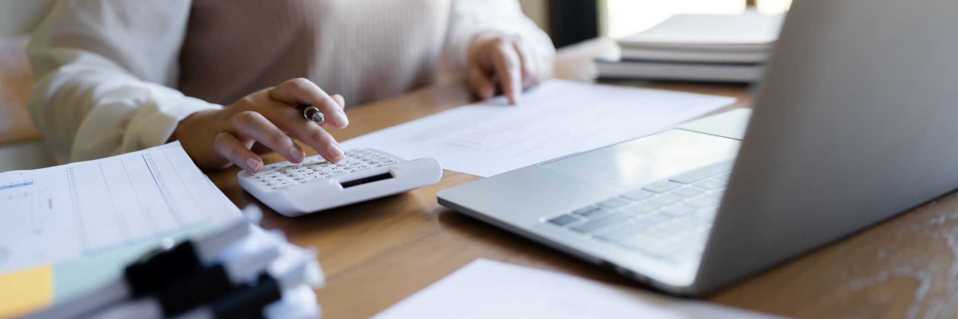 Woman working with a computer and using a calculator