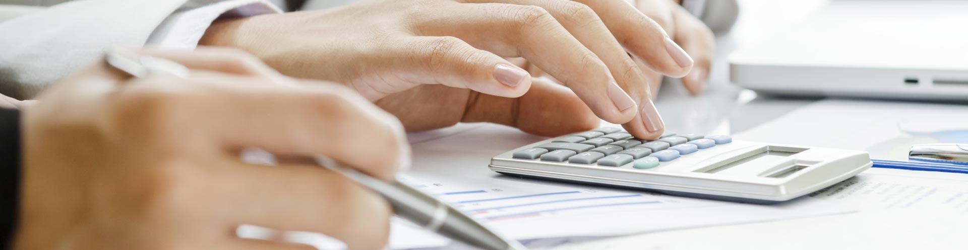 Person working on a calculator. 
