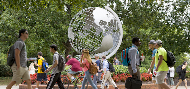 students walking in front of marietta globe