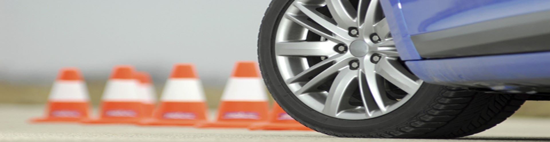 Car in front of caution cones. 