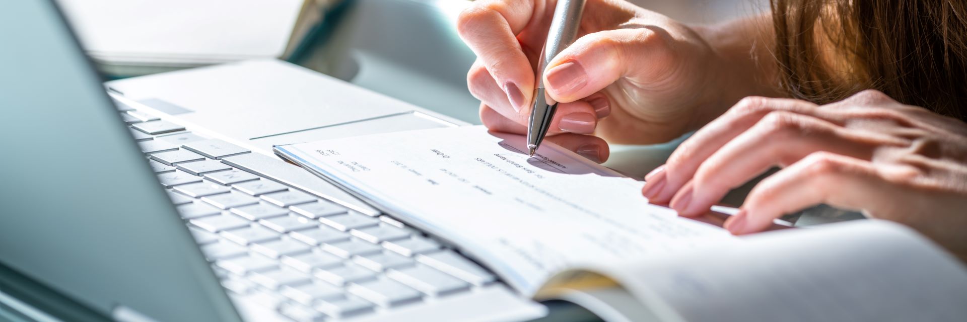 Woman signing a check