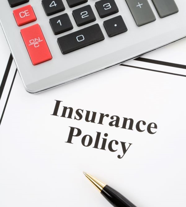 A calculator and document that says "Insurance Policy"