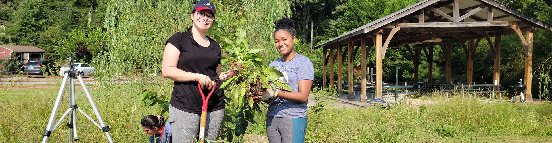 two female ksu students harvesting greens outside