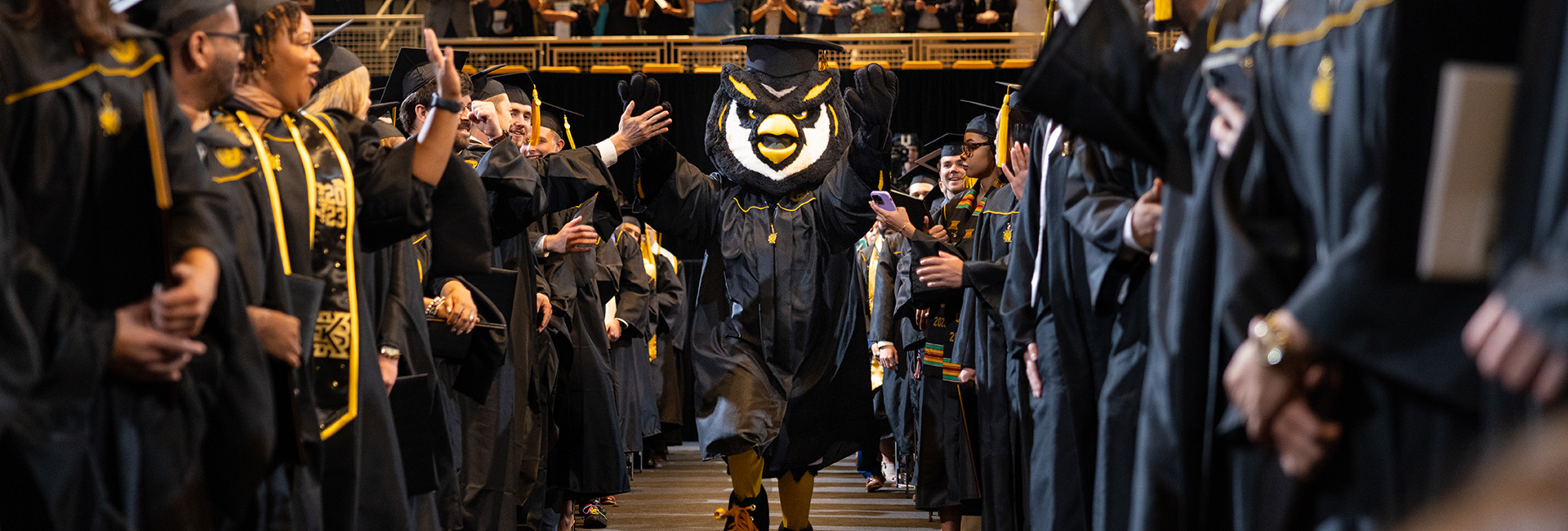 Scrappy running down aisle during commencement ceremony