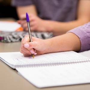 Student taking notes in class