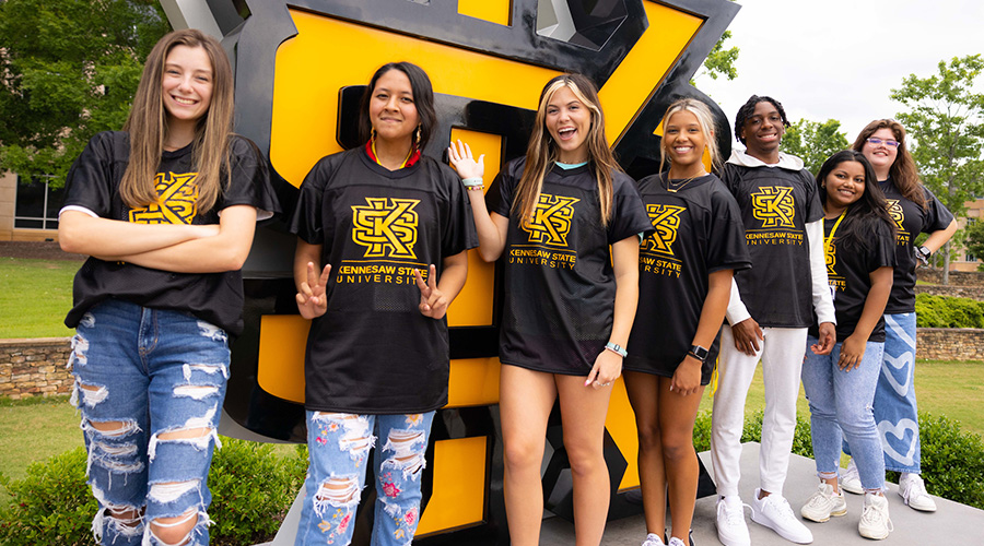 Students in front of KS sign on the Campus Green