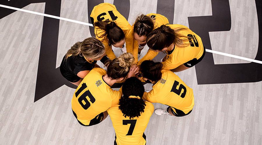 Volleyball team in huddle