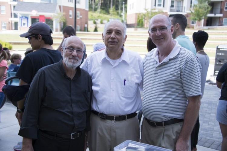  / Dr. Daniel Paracka (right) with Rev. Fahed Abuakel (center) and guest.