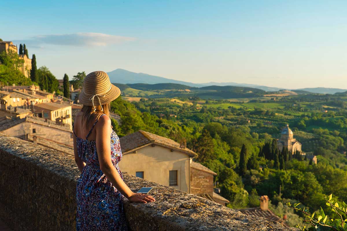 / Montepulciano, Tuscany, Italy, Girl looks at the landscape of the city and countryside from the balcony
