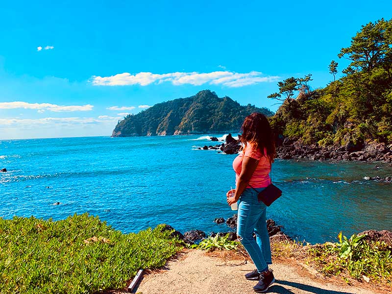 KSU student overlooks blue water and greenery through the Education Abroad Program
