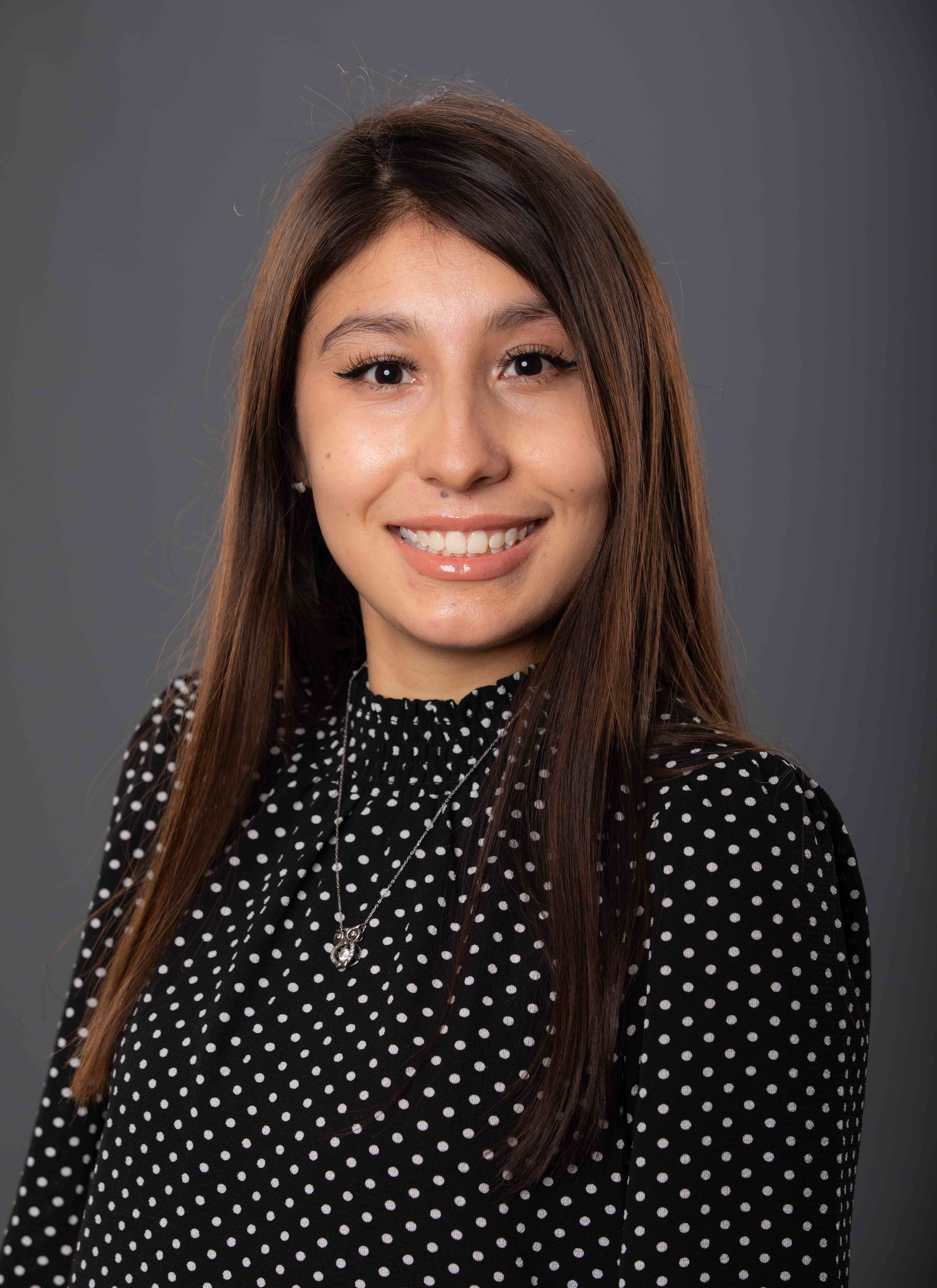 International Student Advisor Calli Rendon Sandoval against a gray backdrop