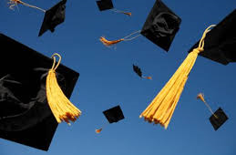 KSU graduation hats flying through the air