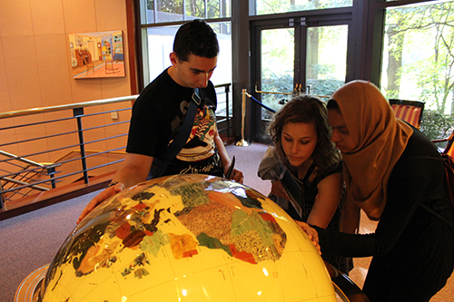 photo of KSU students looking at globe