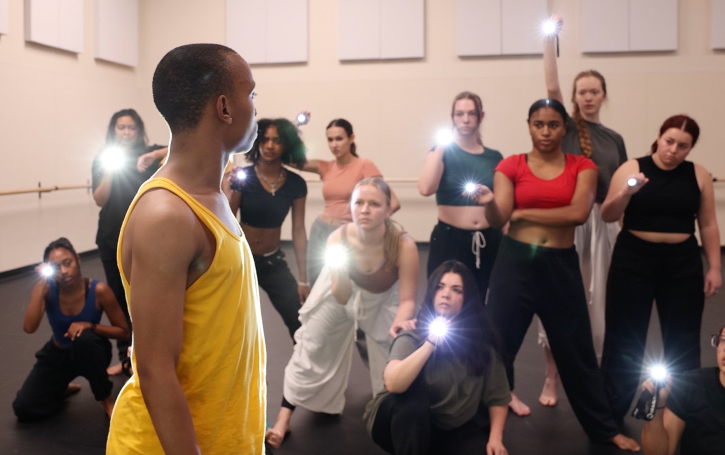 "Borders" features a scene with flashlights that exemplify a universal search for meaning, says dancer Caleb Joyner, foregrounded here at a rehearsal last week.