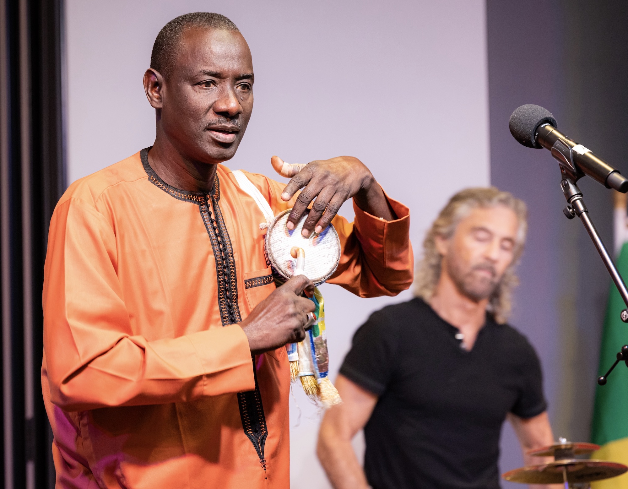 Massamba Diop demonstrates the 'talking drum' accompanied by percussionist Tony Vacca.