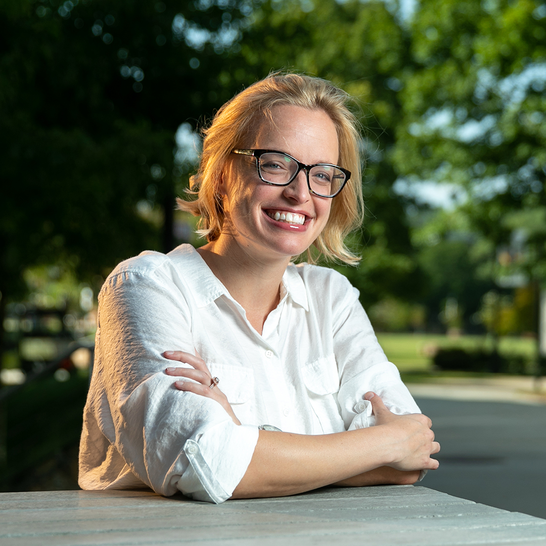 female with glasses and blonde hair smiling