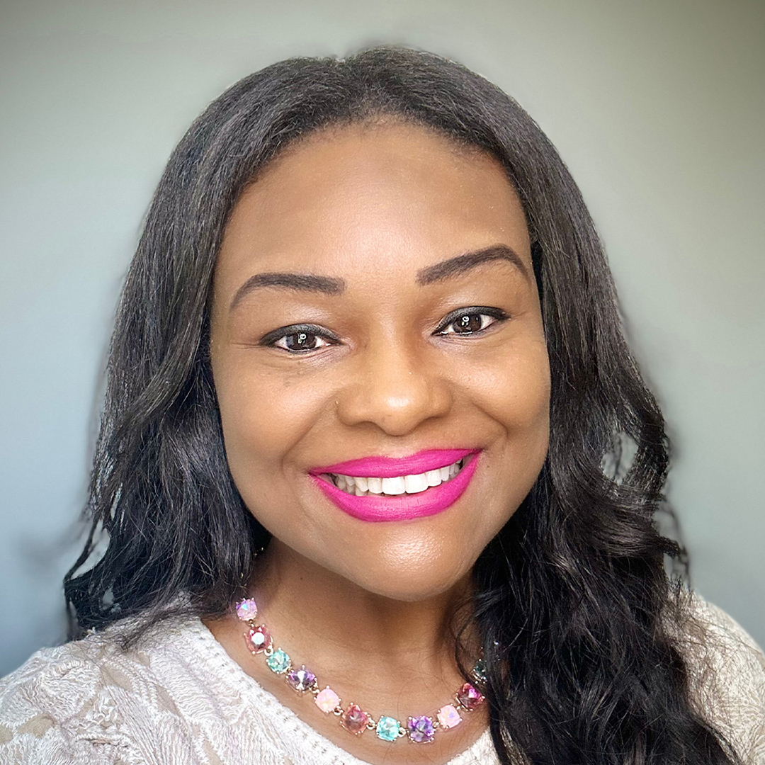 A woman with long hair looking cheerful and relaxed.