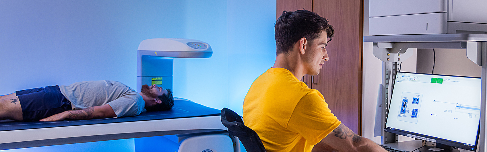 exercise science student using state of the art equipment on another student