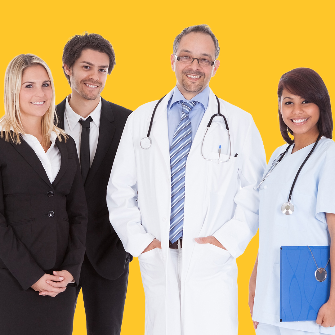 group of healthcare workers smiling, some in suits, some in doctor and nurse outfits