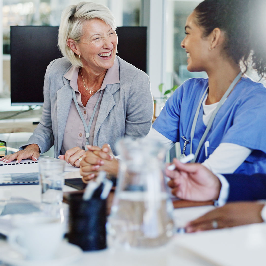 Healthcare professionals meeting to discuss patient care coordination in a clinical environment.