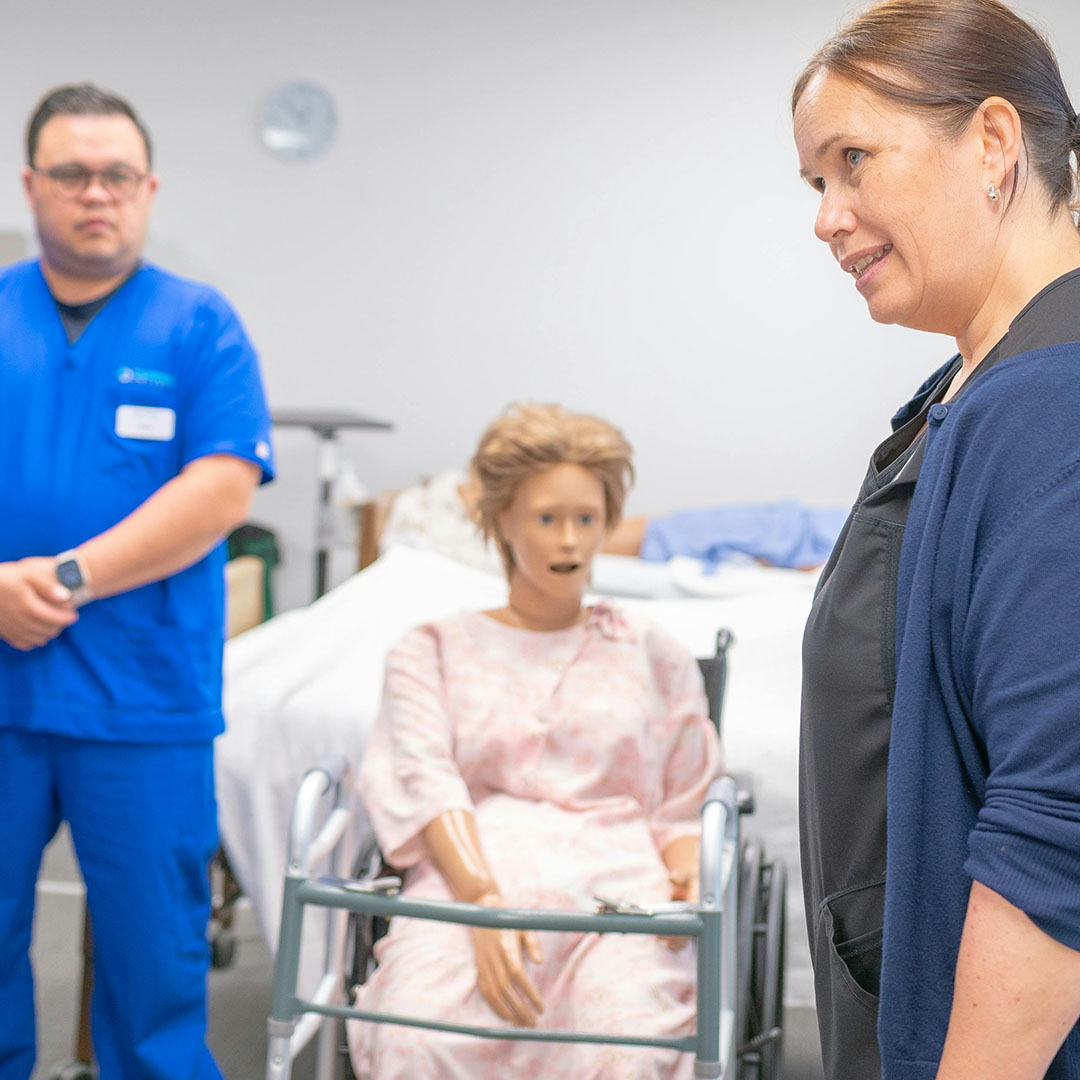 Nursing professionals engaged in instructional discussion within an academic learning environment.
