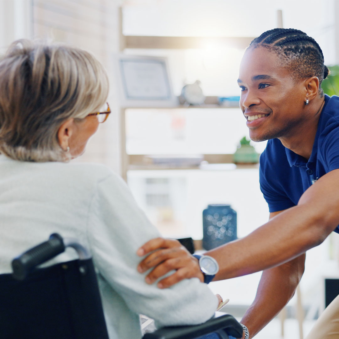 Social work professional assisting an older adult in a healthcare setting