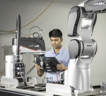 male student working robotics equipment