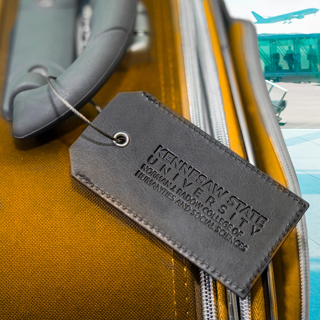close up of ksu tag on yellow suitcase