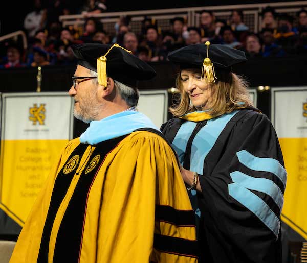 ksu graduate college student graduating at commencement ceremony