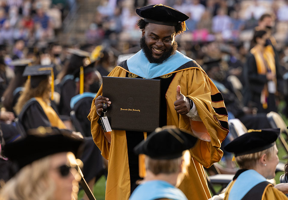 male graduate student at commencement ceremony