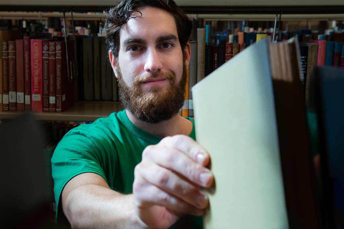 male ksu graduate college student in library 