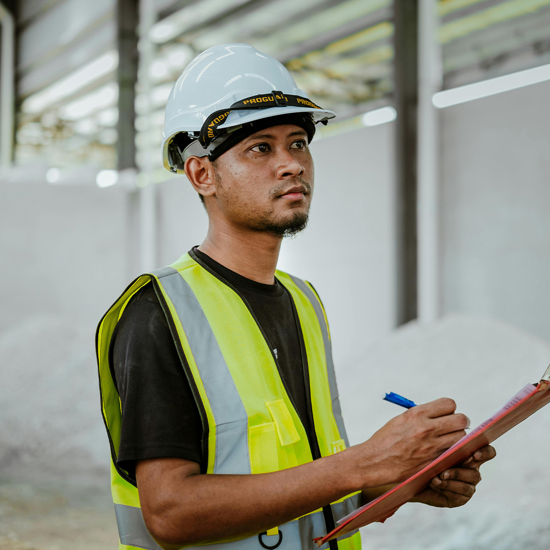 construction managemer taking notes on site