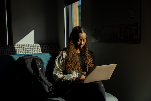 ksu female student working on lap top