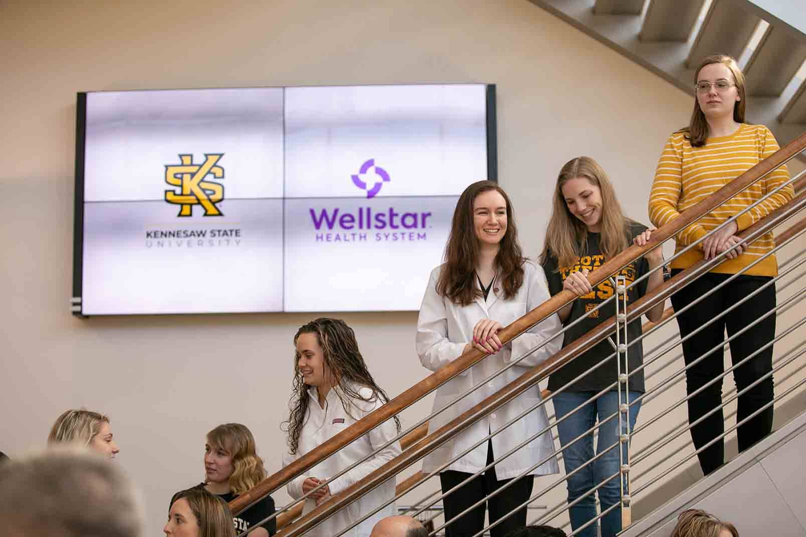 ksu nursing student standing on stairwell