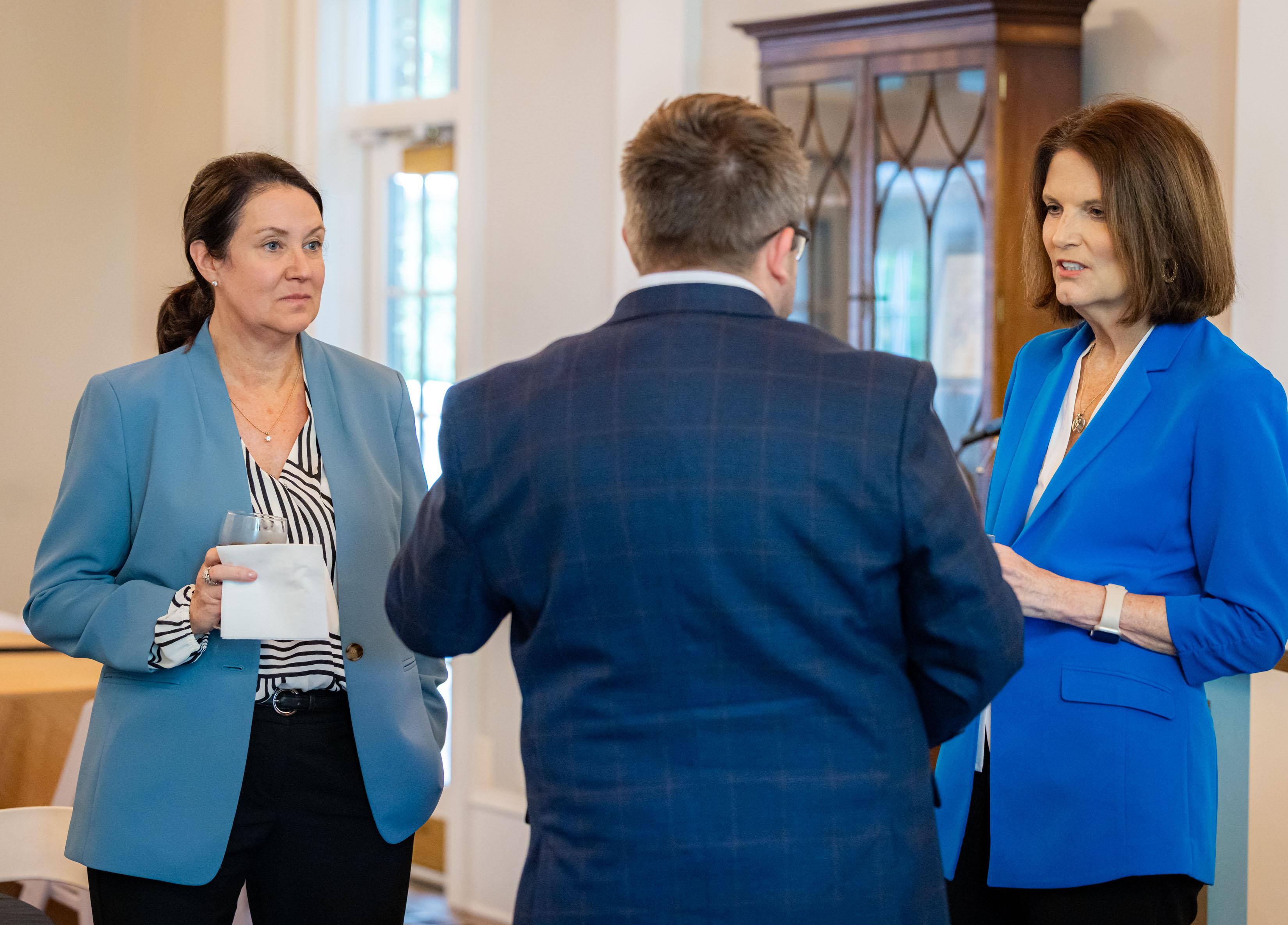  / president, kathy schwaig speaking with guests