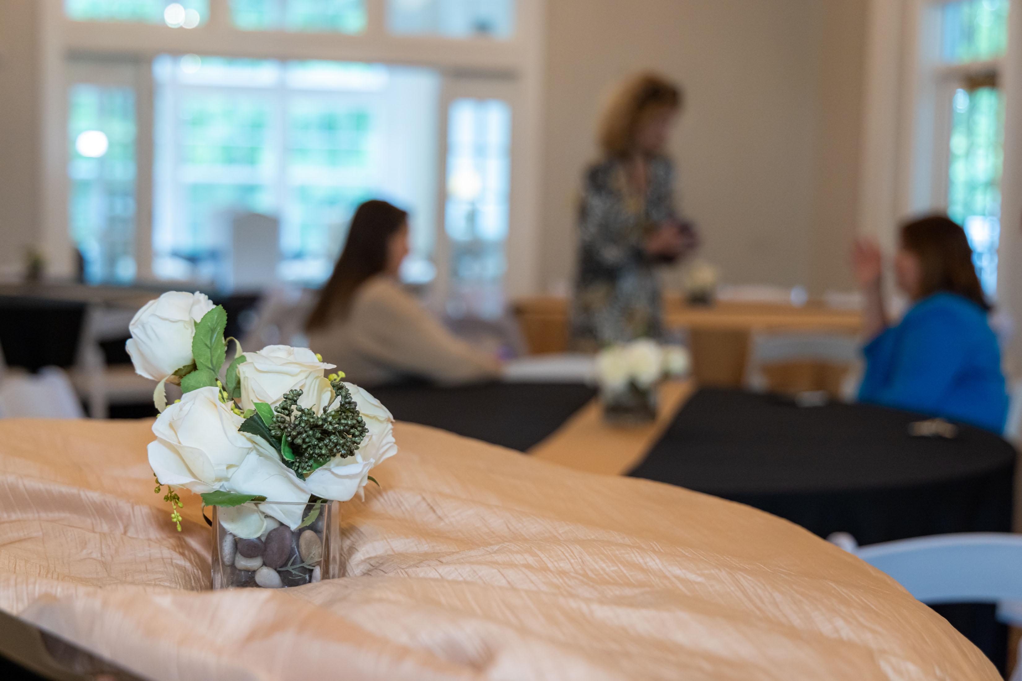  / flowers on table with guests in background