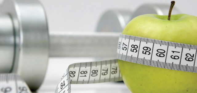 apple, tape measure, and exercise weight