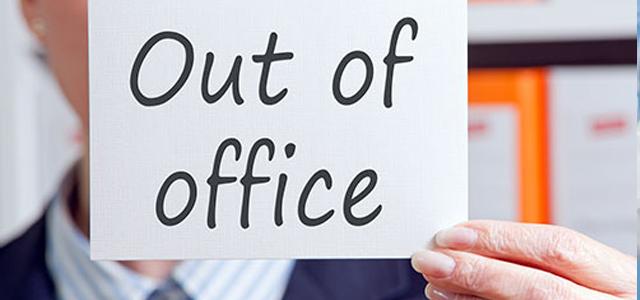 hand holding out of office sign