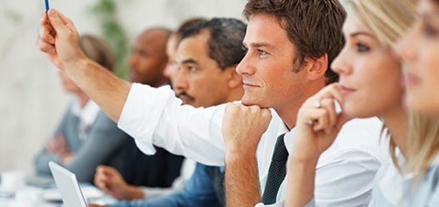 group of business professionals sitting at desks