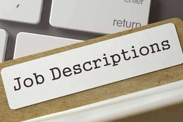 file folder that says job descriptions over keyboard.