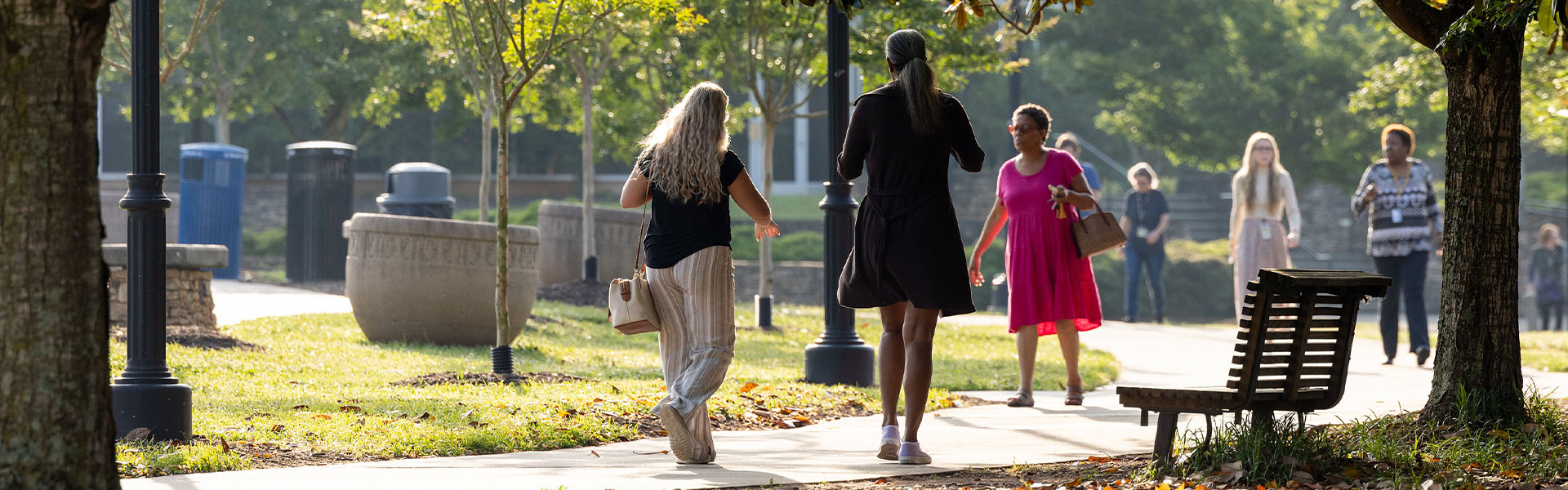 KSU faculty memebers walking on the kennesaw campus green.