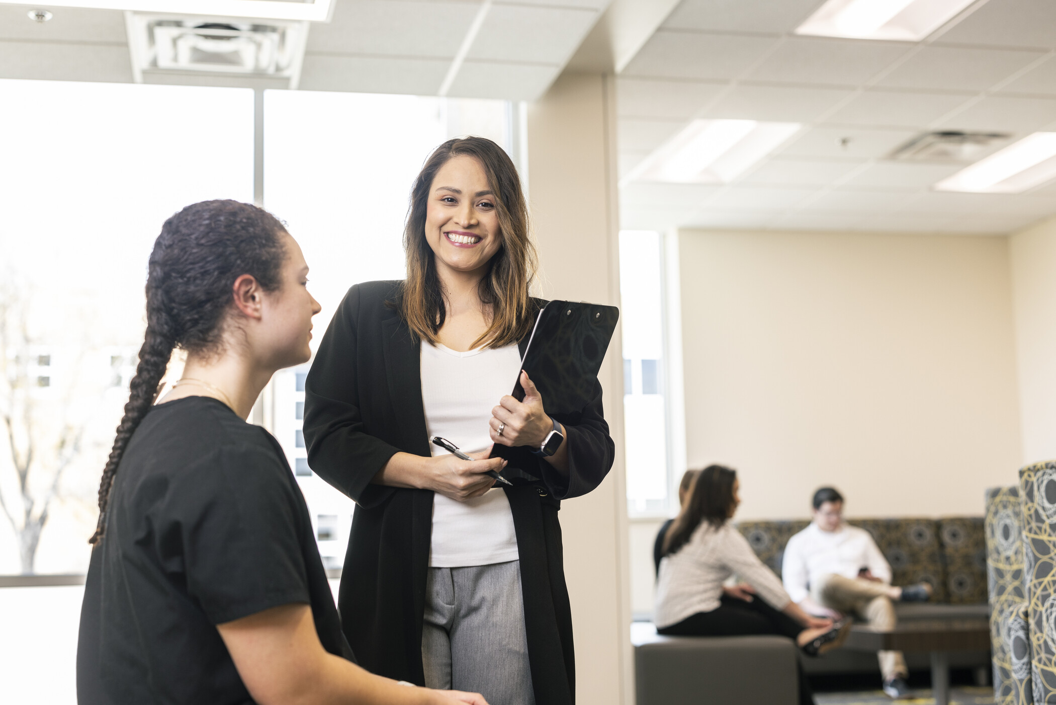 two hands overlapping, with one person dressed in fatigues