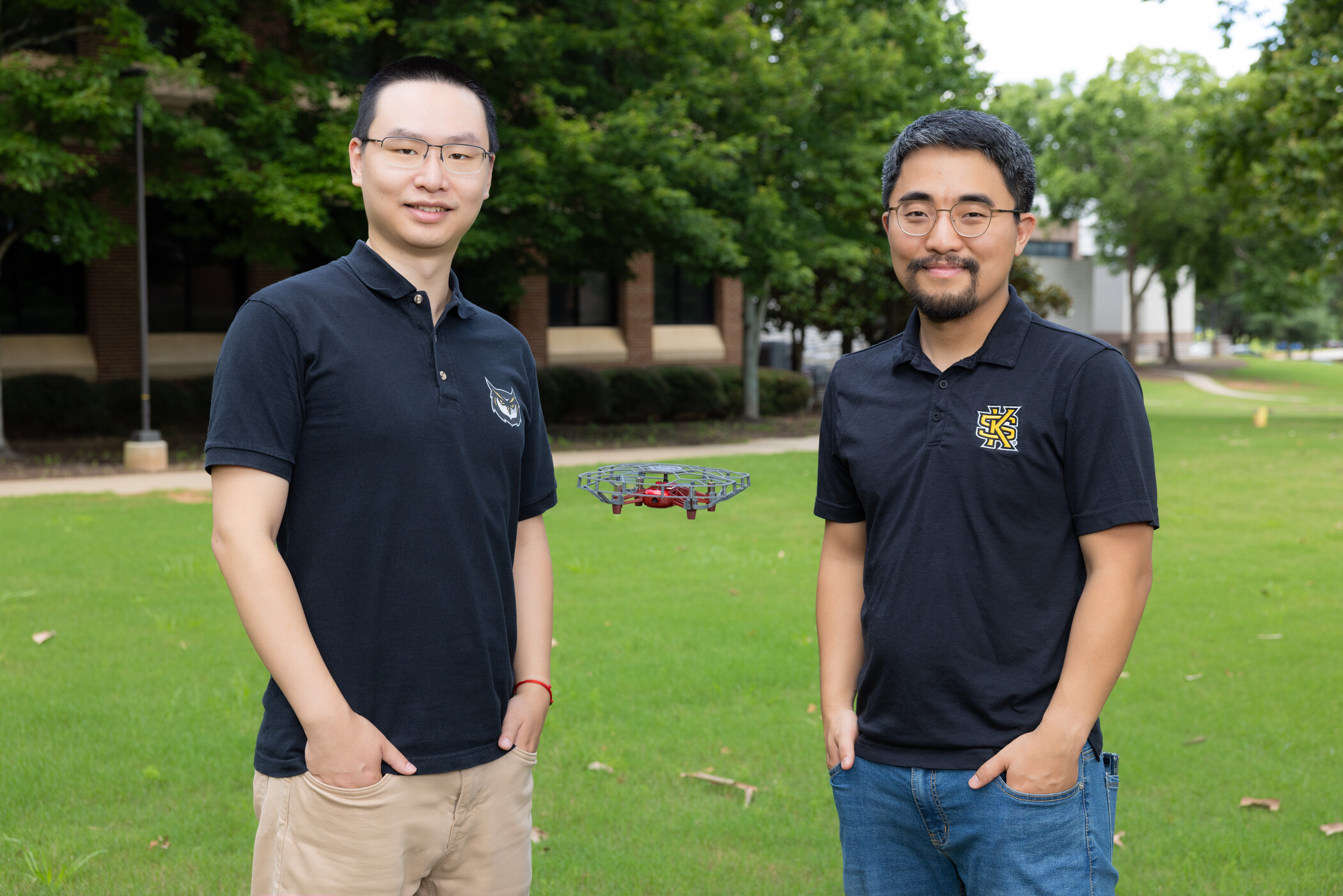 a man standing with a drone suspended in air