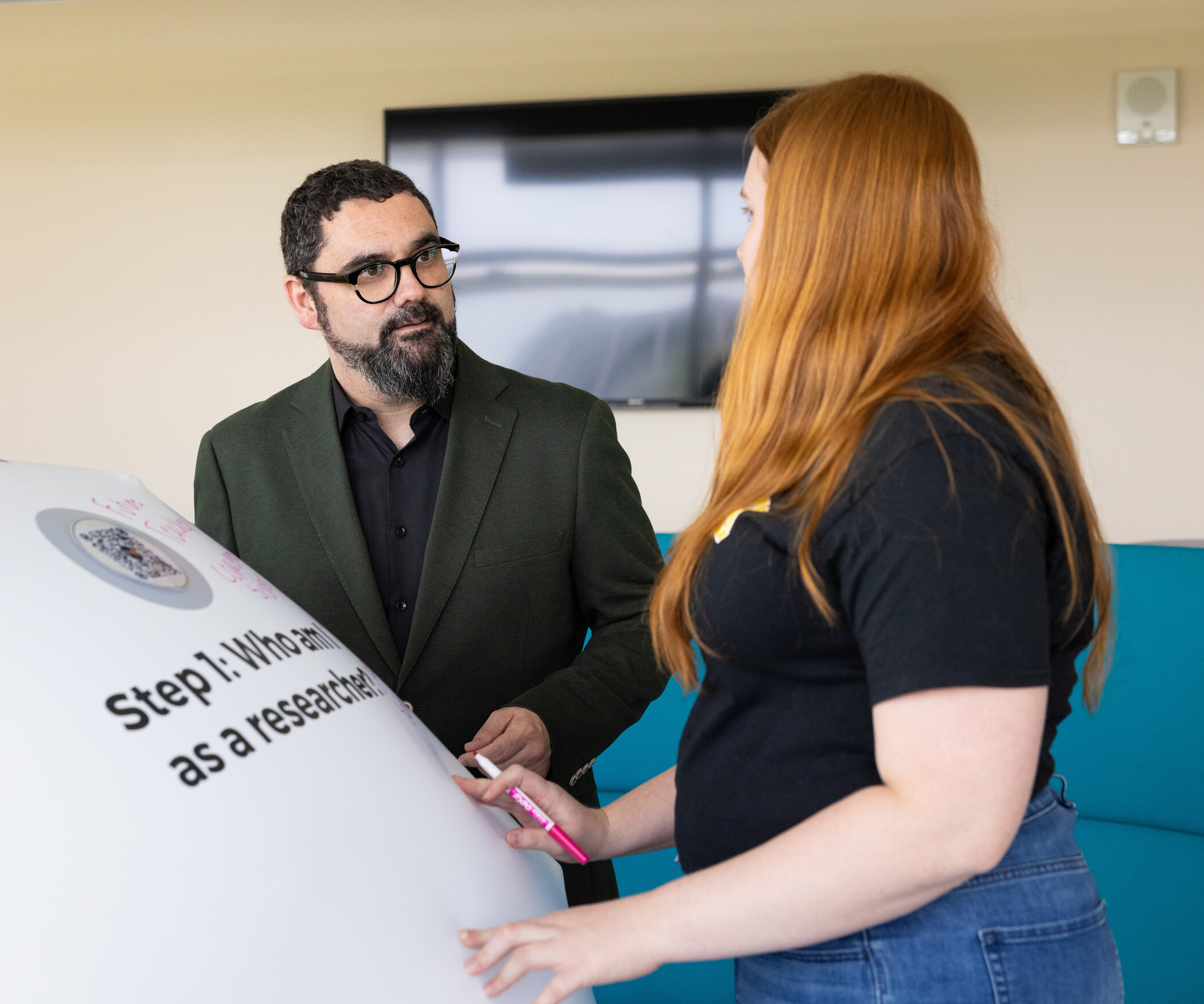 two people standing near inflatable ball
