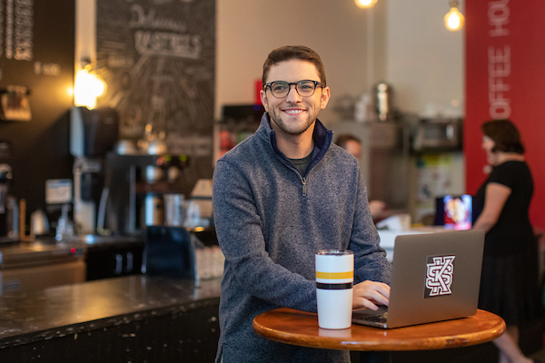 KSU student attending class while in a coffee shop