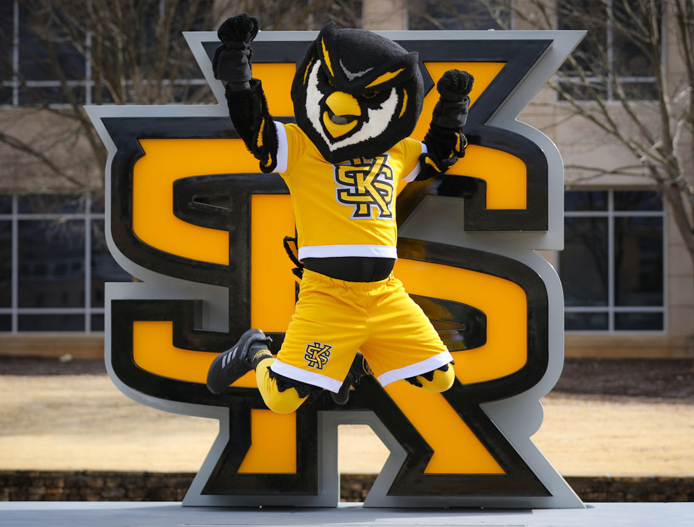 Scrappy jumping in front of the KS logo