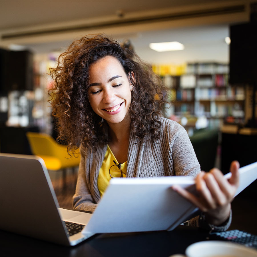 Young mature woman looking down at her notebook