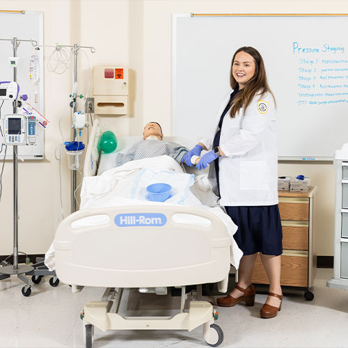 ksu nursing student working on a test dummy.