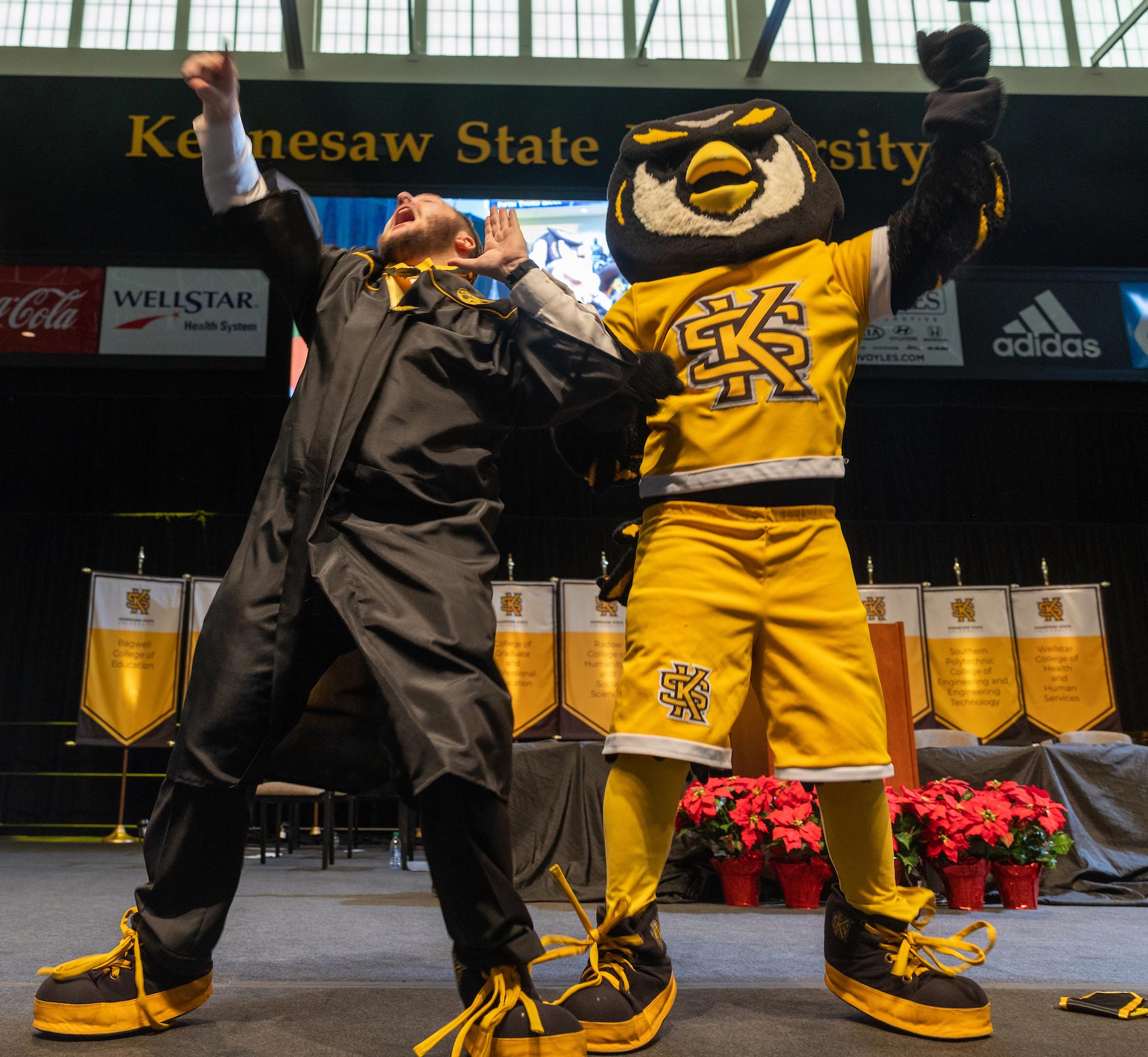 Student celebrating with Scrappy at graduation